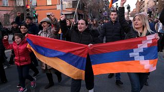 Opposition demonstrators carrying Armenian national and region of Nagorno-Karabakh’s flag. Armenia, Saturday, Feb. 27, 2021.