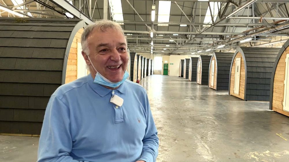 Former soccer player Lou Macari installs dormitory booths for the homeless