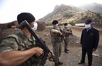 Turkish Defense Minister Hulusi Akar, fright wearing a face mask to protect against coronavirus, visits Turkish troops at the border with Iraq, in Hakkari province, Turkey.