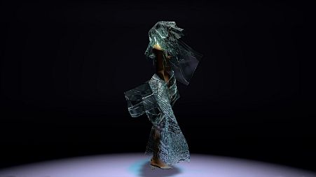 3D model wearing a dress made from algae designed by Scarlett Yang.