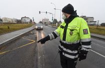 A Czech police officer stops a car on a road between the towns, Ostrava and Opava.