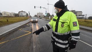 A Czech police officer stops a car on a road between the towns, Ostrava and Opava.