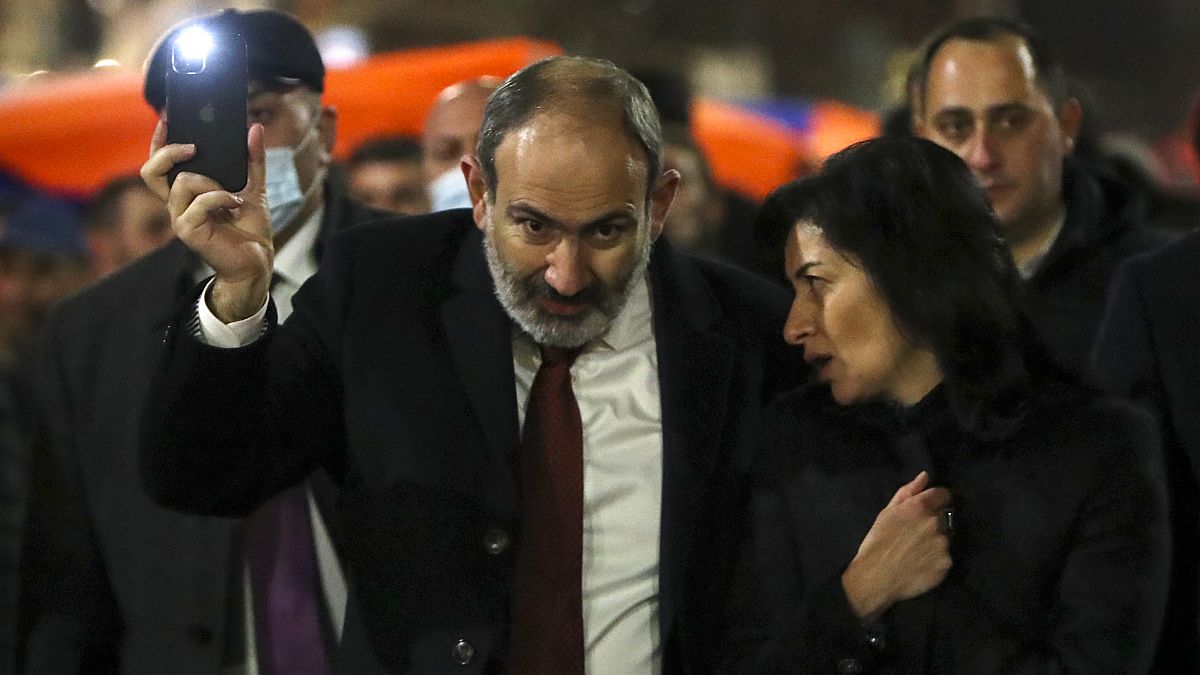 Armenian Prime Minister Nikol Pashinyan and his wife Anna Akobyan walk with supporters during a rally in his support in the center of Yerevan