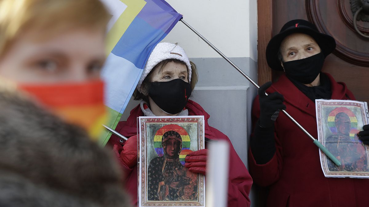Polish LGBT rights activists gather outside a court which acquitted three women who faced trial on accusations of desecration, in Plock, Poland, Tuesday March 2, 2021