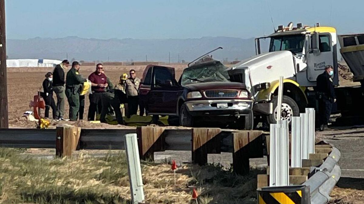 In this image from KYMA, law enforcement work at the scene of a deadly crash involving a semi-truck and an SUV in Holtville, Calif., on Tuesday, March 2, 2021. (KYMA via AP)