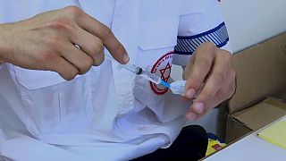 An Israeli healthcare worker administers a vaccine in Jerusalem