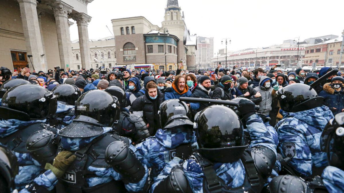 Jan. 31, 2021 file photo, people clash with police during a protest against the jailing of opposition leader Alexei Navalny in Moscow, Russia.