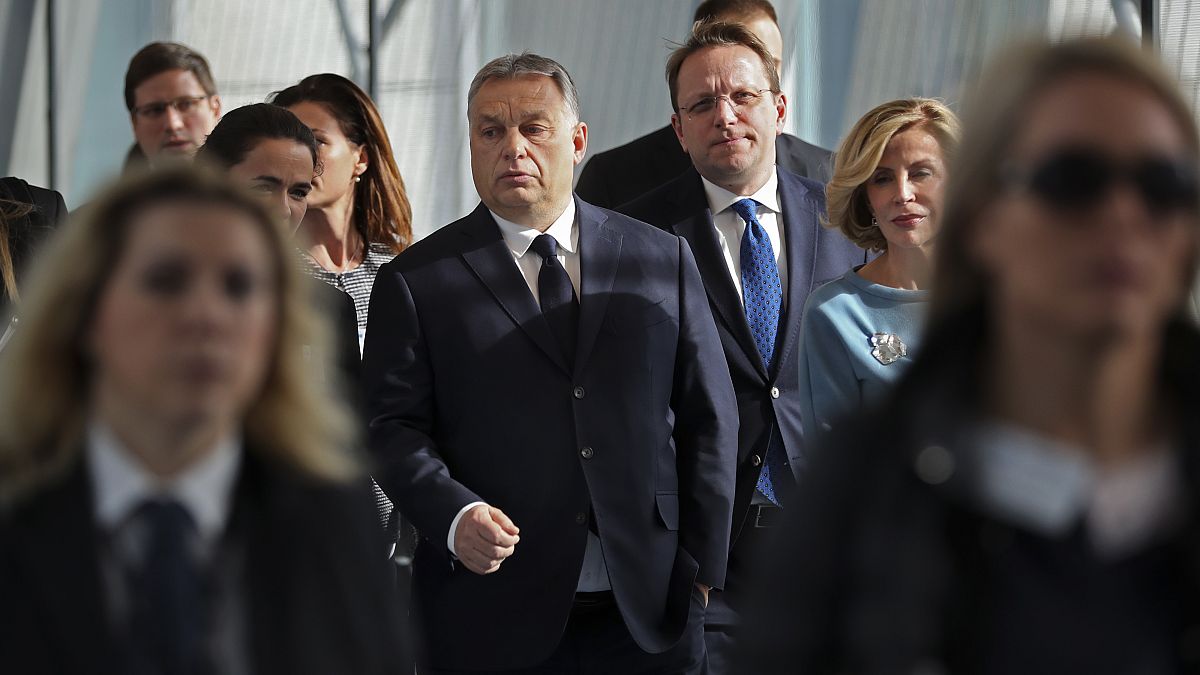 In this Wednesday, March 20, 2019 file photo, Hungarian Prime Minister Viktor Orban, center, arrives to a European People's Party's meeting in Brussels.