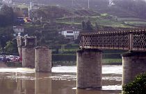 A rescue helicopter circles above the remains of the bridge on March 5, 2001.