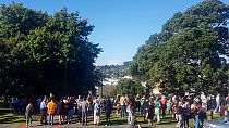 People gather on high ground in Whangarei, New Zealand, as a tsunami warning is issued