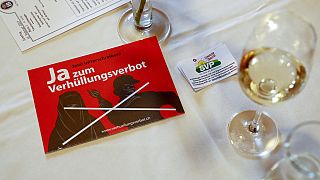 In this Feb. 12, 2017 file photo a leaflet reading "Yes to the ban on veiling'' is on display at the reunion of the Swiss People's Party SVP in Dornach, Switzerland