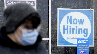 Una persona pasa por delante de una oferta de empleo en Illinois, EE.UU.