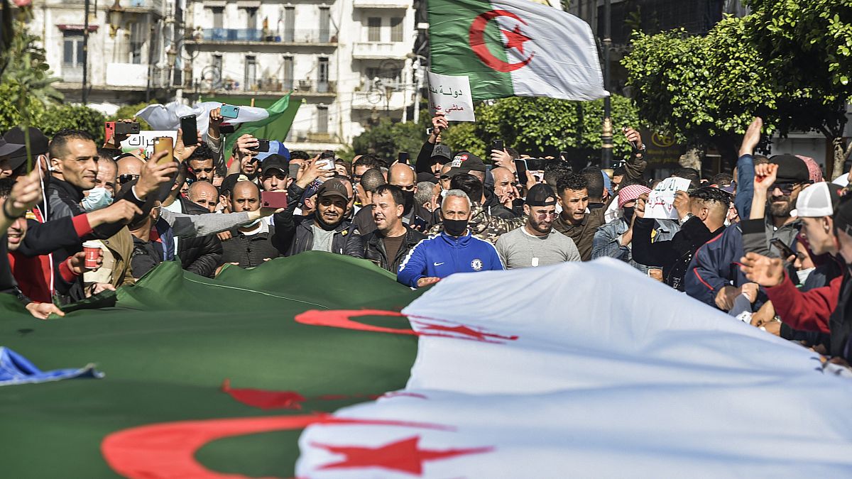 جزائريون يرفعون الأعلام خلال مظاهرة  في العاصمة الجزائر. 2021/03/05