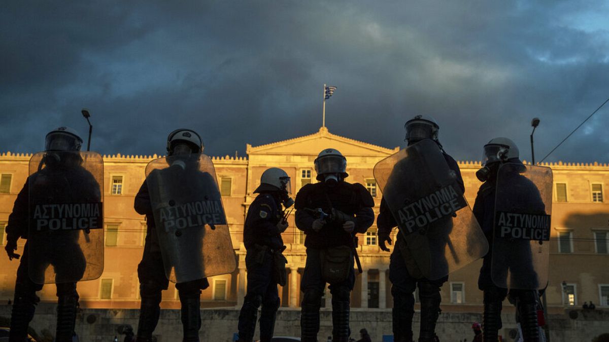 Riot police stand guard in front of the Greek parliament in central Athens