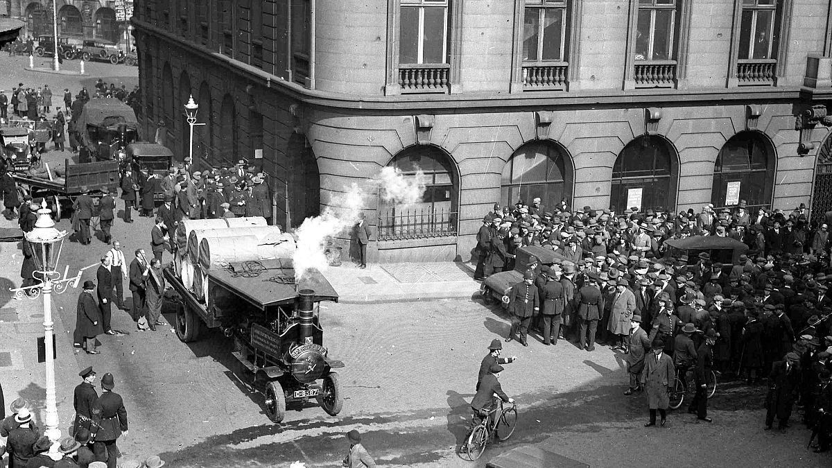 Police, right, keep strikers away from a steam driven engine towing rolls of paper, in London, May 3, 1926, during the General Strike. 
