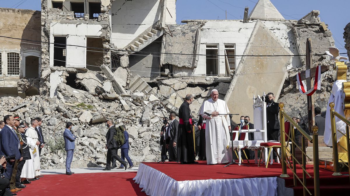 Pope Francis, surrounded by shells of destroyed churches, arrives to pray for the victims of war at Hosh al-Bieaa Church Square, in Mosul, Iraq.