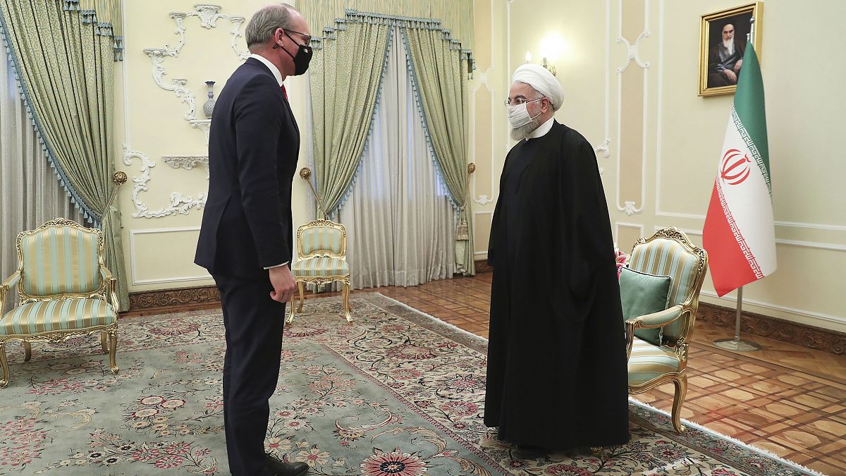 Iranian President Hassan Rouhani, right, and Irish Foreign Minister Simon Coveney greet at the start of their meeting in Tehran, Iran, Sunday, March 7, 2021.