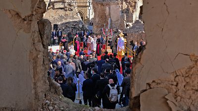 Pope Francis addresses people from the podium at the square near the ruins of the Syriac Catholic Church of the Immaculate Conception.