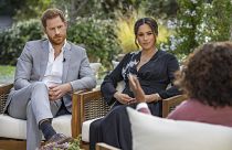 This image provided by Harpo Productions shows Prince Harry, left, and Meghan, Duchess of Sussex, in conversation with Oprah Winfrey. 