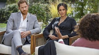 This image provided by Harpo Productions shows Prince Harry, left, and Meghan, Duchess of Sussex, in conversation with Oprah Winfrey. 