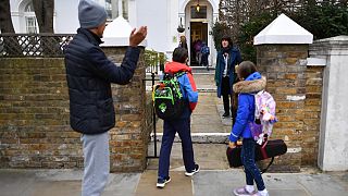 Children are dropped off by their parents at Southbank International School in London on March 8, 2021 as schools reopen.