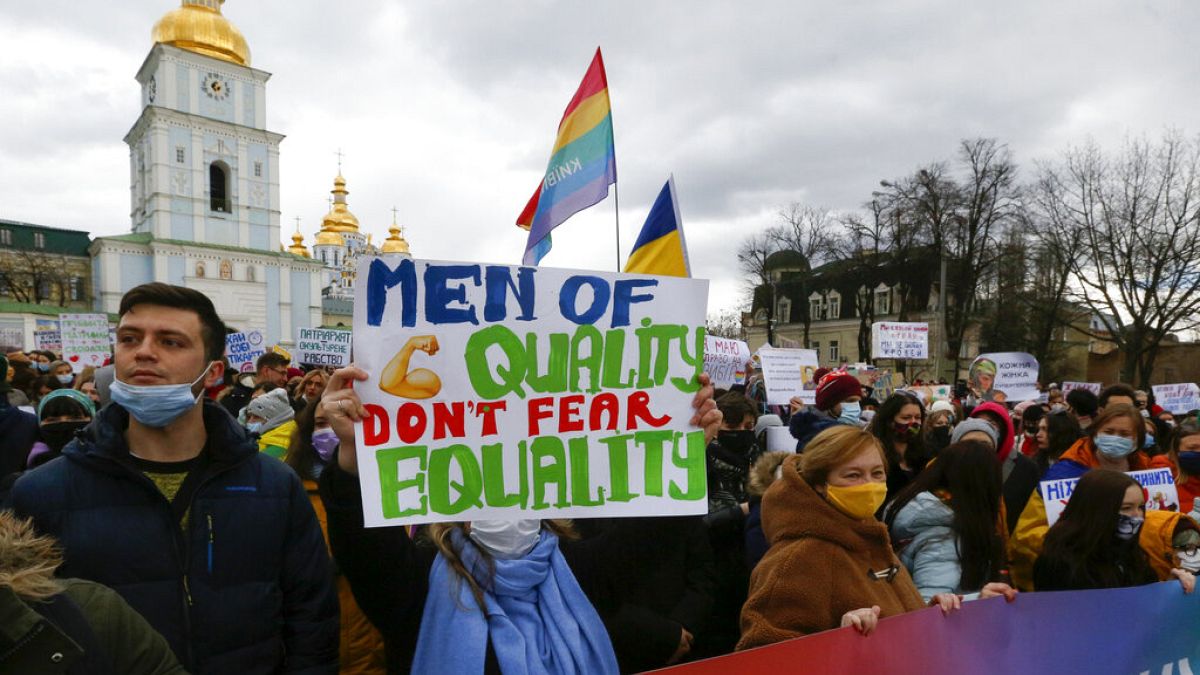 Activists shouts slogans at a rally on the occasion of the International Women's Day in Kyiv, Ukraine, Monday, March 8, 2021