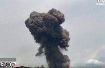 TVGE image made from video shows smoke rising over the blast site at a military barracks in Bata, Equatorial Guinea, Sunday, March 7, 2021.