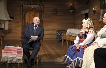 Belarusian President Alexander Lukashenko, sits on stage talking to a group of actors during his visit to the Yanka Kupala National Theater in Minsk, Friday, Feb. 19, 2021
