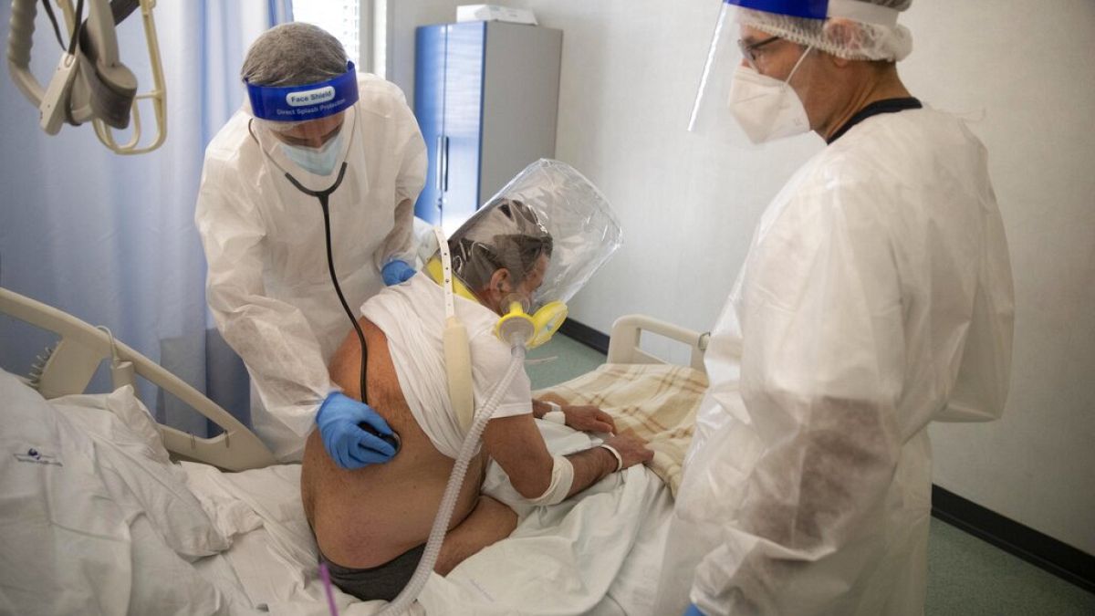 Doctors tend to a patient in the emergency COVID-19 ward at Mellino Mellini hospital in Chiari, northern Italy