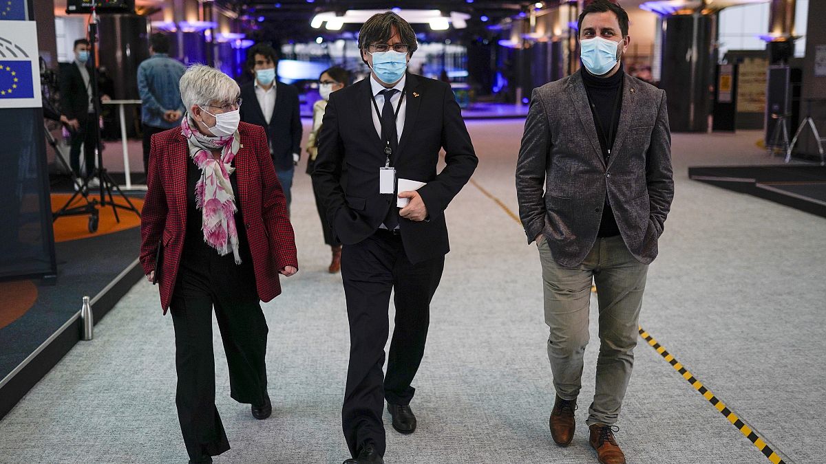 From right, MEPs Antoni Comin, Carles Puigdemont and Clara Ponsati speak with each other prior to a media conference at the European Parliament in Brussels. March 9, 2021., 