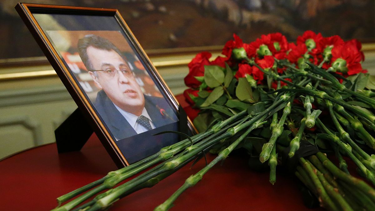 Flowers lay next to a portrait in memory of Russian Ambassador to Turkey, Andrei Karlov.