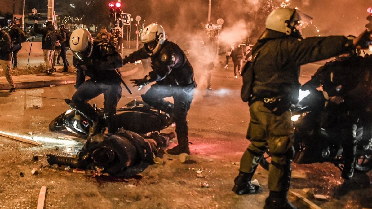 Motorised police arrive to tend to their injured colleague during a demonstration against police violence in an Athens suburb on March 9, 2021. 