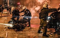Motorised police arrive to tend to their injured colleague during a demonstration against police violence in an Athens suburb on March 9, 2021.