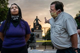 Anais (26) argues for the removal of the Emancipation Memorial with a man (right) who wishes to keep it, in Lincoln Park, Washington DC, USA. June 25, 2021