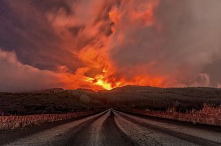 A glowing river of lava gushes from the slopes of Mt Etna, Europe's largest active volcano, near Zafferana Etnea, Sicily