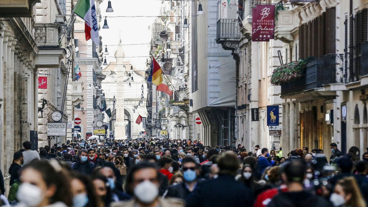 People crowd Via del Corso shopping street in Rome