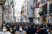 People crowd Via del Corso shopping street in Rome