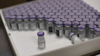 FILE - In this Monday, Jan. 4, 2021 file photo, frozen vials of the Pfizer/BioNTech COVID-19 vaccine are taken out to thaw, at the MontLegia CHC hospital in Liege, Belgium.