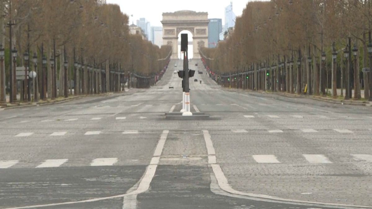 Deserted Avenue des Champs-Elysées with the Arc de Triomphe in the background - Paris, March 29, 2020