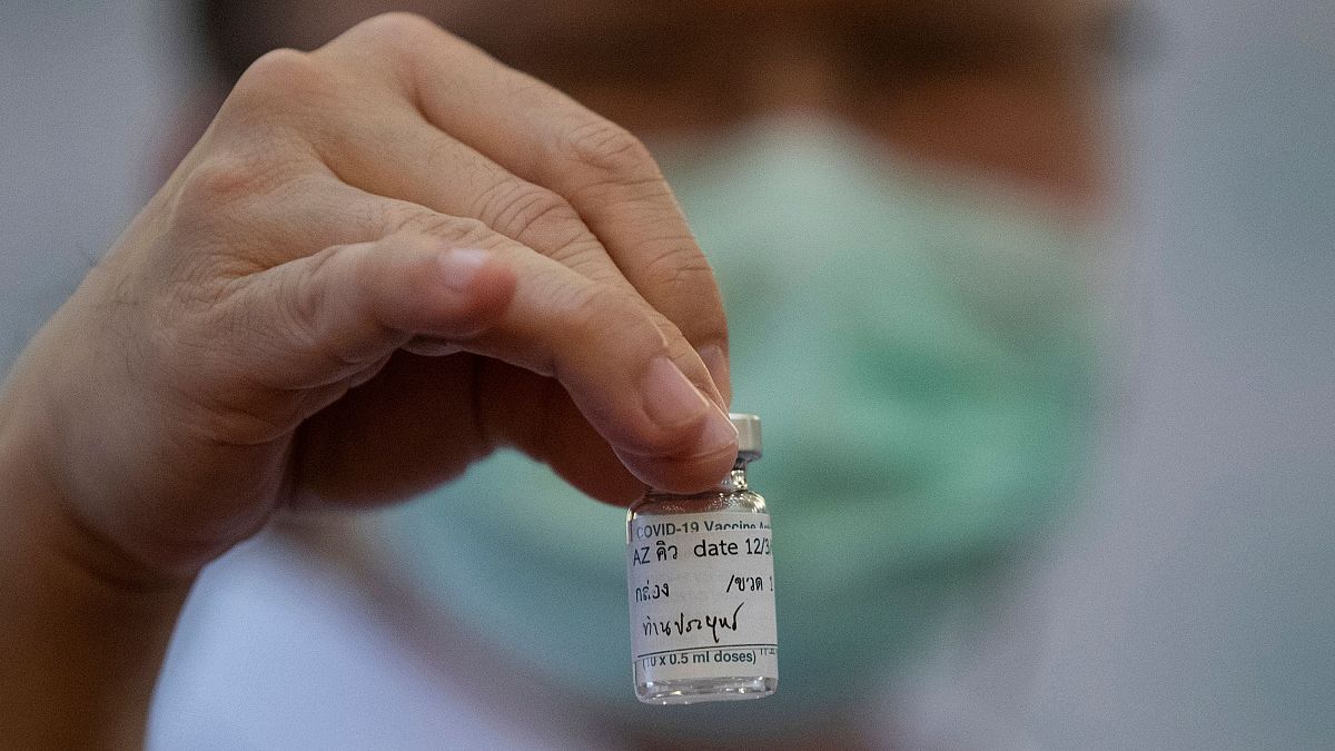 A health worker holds a bottle of AstraZeneca COVID-19 vaccine with name Thailand's Prime Minister Prayuth Chan-ocha written on it