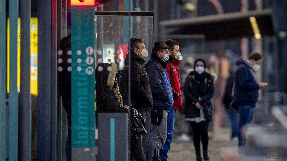 People wearing face masks wait for a train at a subway station in Frankfurt, Germany, Friday, March 12, 2021, as the number of Corona infections in Germany rises again.