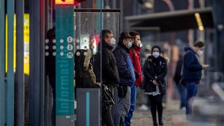 People wearing face masks wait for a train at a subway station in Frankfurt, Germany, Friday, March 12, 2021, as the number of Corona infections in Germany rises again.