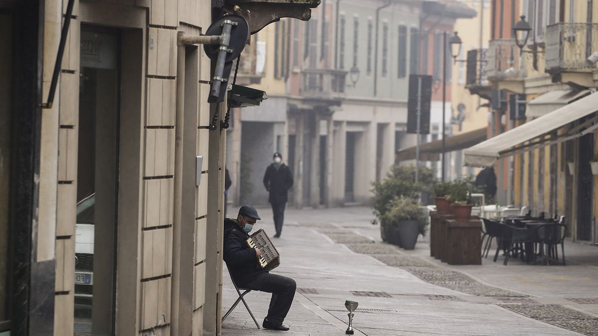 A man plays an accordion in Codogno, northern Italy, Sunday, Feb. 21, 2021. 