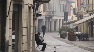 A man plays an accordion in Codogno, northern Italy, Sunday, Feb. 21, 2021.
