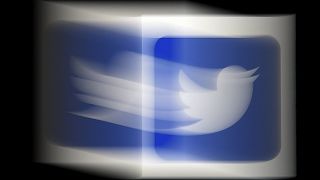 (FILES) In this file photo illustration, a Twitter logo is displayed on a mobile phone on August 10, 2020, in Arlington, Virginia