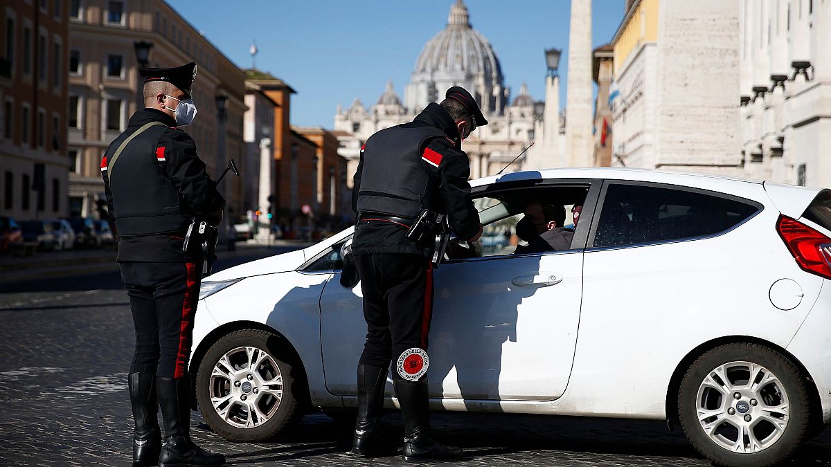 Carabinieri police officers stop a car in Rome, after the region was locked down once again