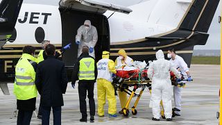 A patient infected with COVID-19 is loaded into a plane heading to a western France hospital, at Orly airport, south of Paris, Sunday, March 14, 2021.