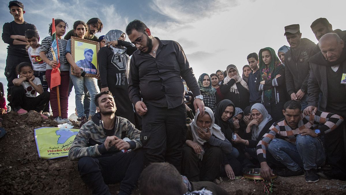 File: people attend the funeral of a Syrian Democratic Forces fighter, killed in a battle with remnants of the Islamic State group in eastern Syria. March 10, 2020.