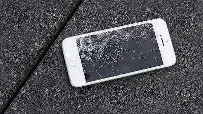 A broken Apple iPhone in need of repairs.