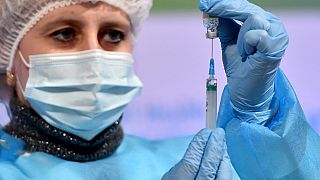 A medical worker draws up a dose of the Oxford/AstraZeneca vaccine against the coronavirus
